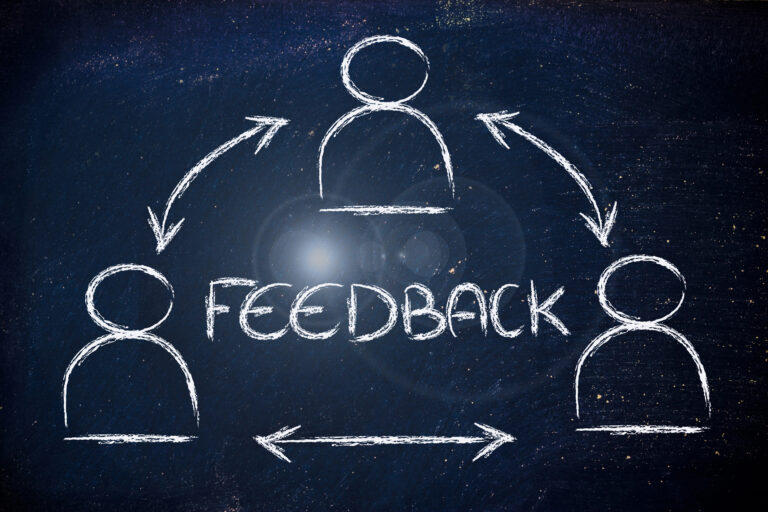 Chalkboard feedback diagram with arrows and people icons.